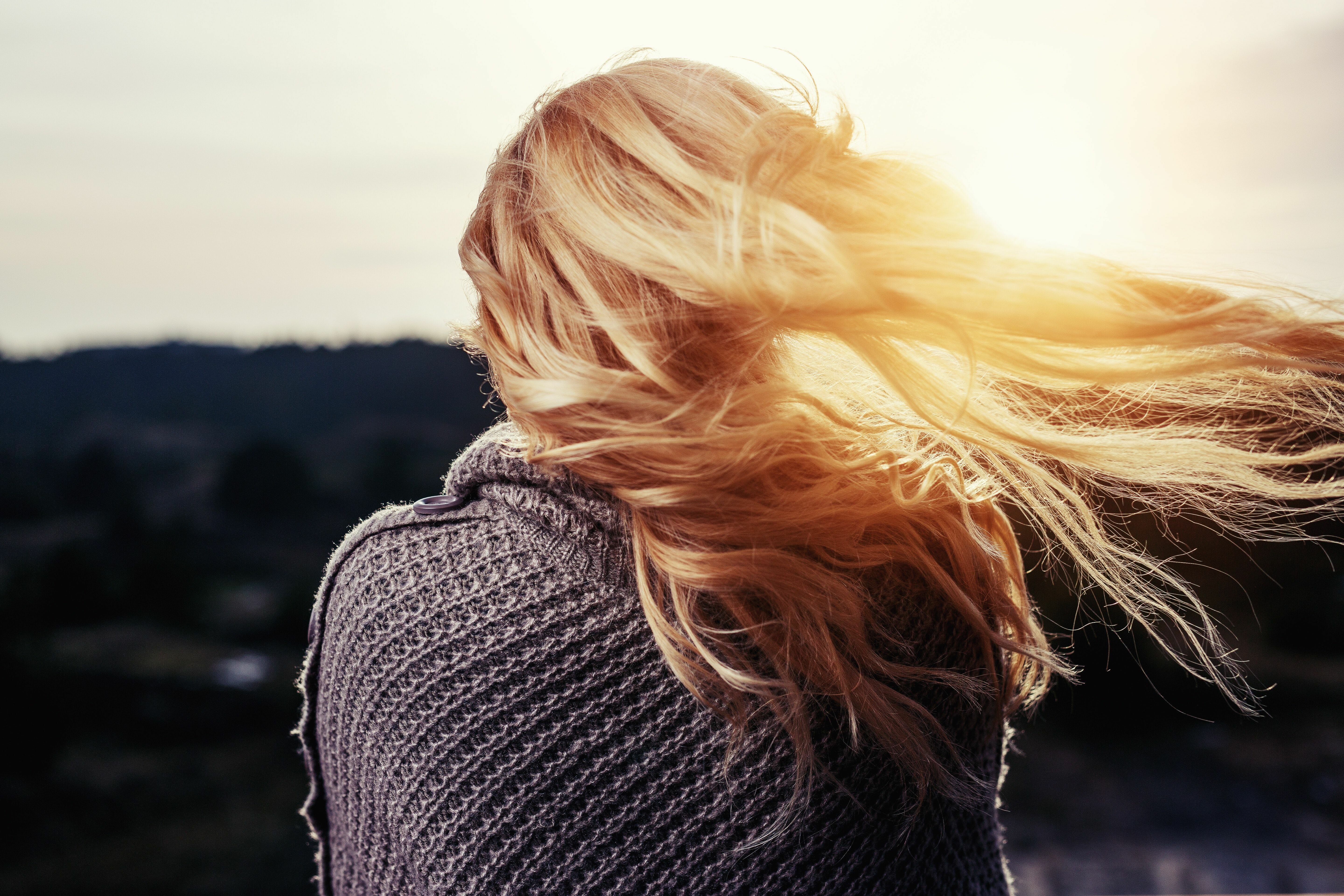 woman with long blond hair wavering